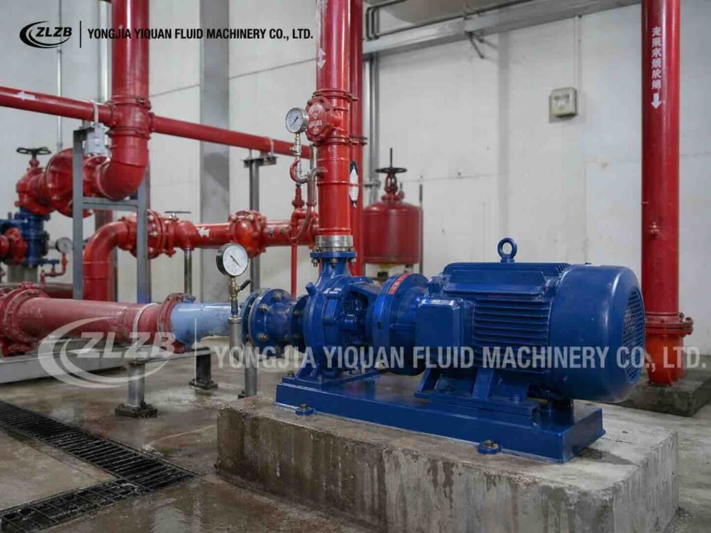 Blue ISW horizontal centrifugal pump connected to red fire-water pipes and pressure gauges.